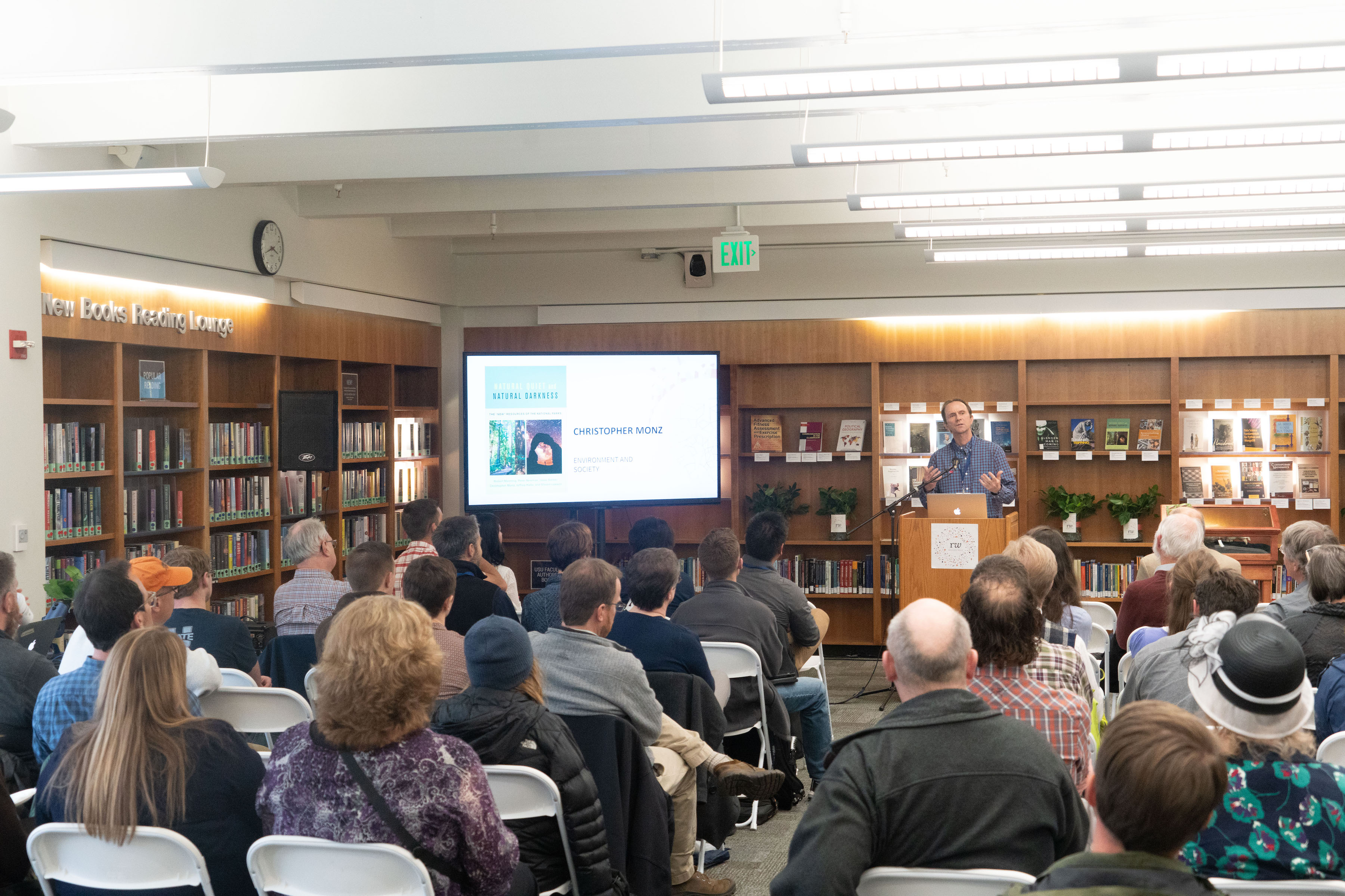 Man speaking to a seated crowd at the 2019 Faculty Author Exhibition