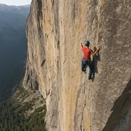 person climbing a rock