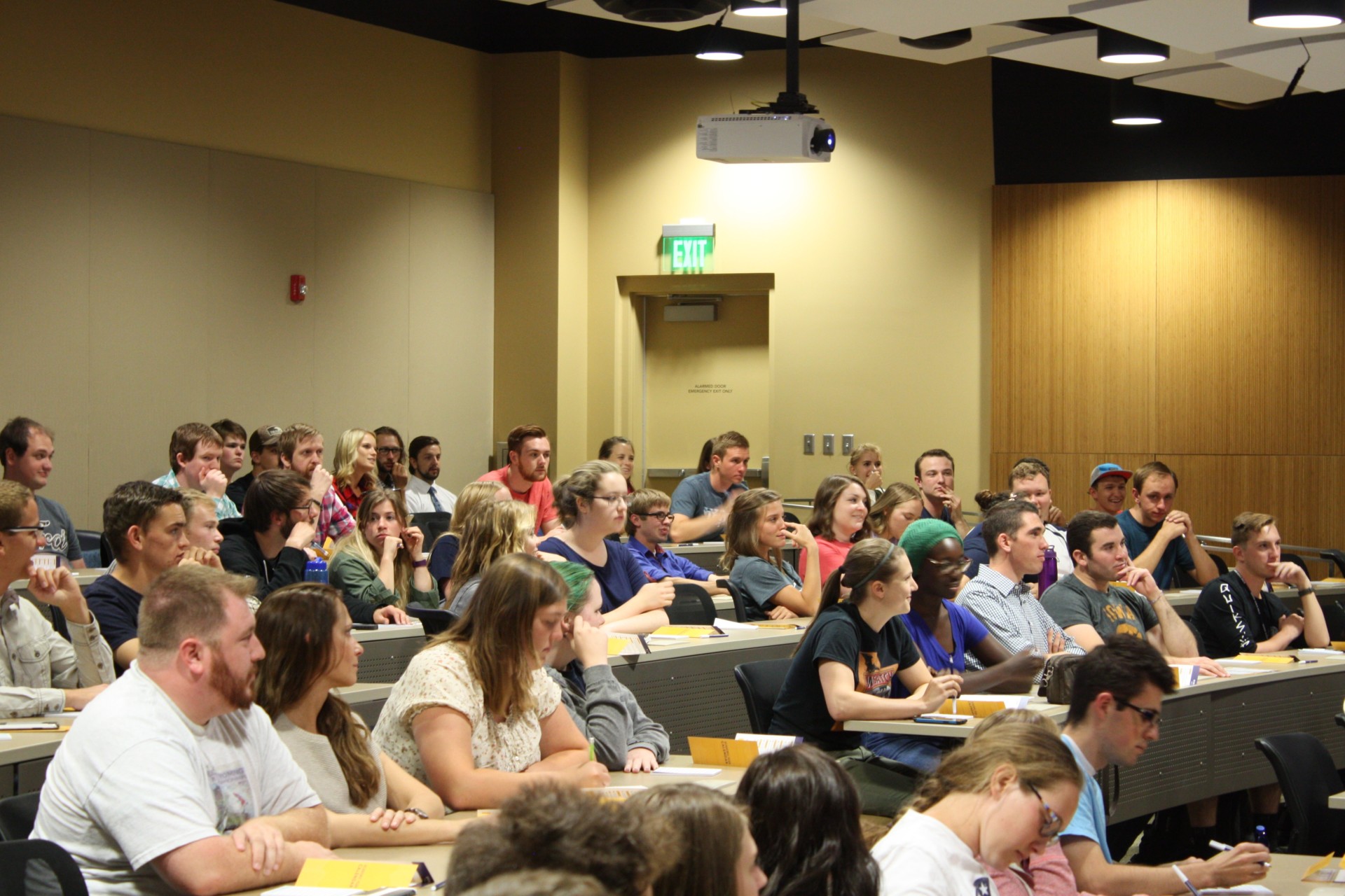 Many students listening attentively in a lecture hall