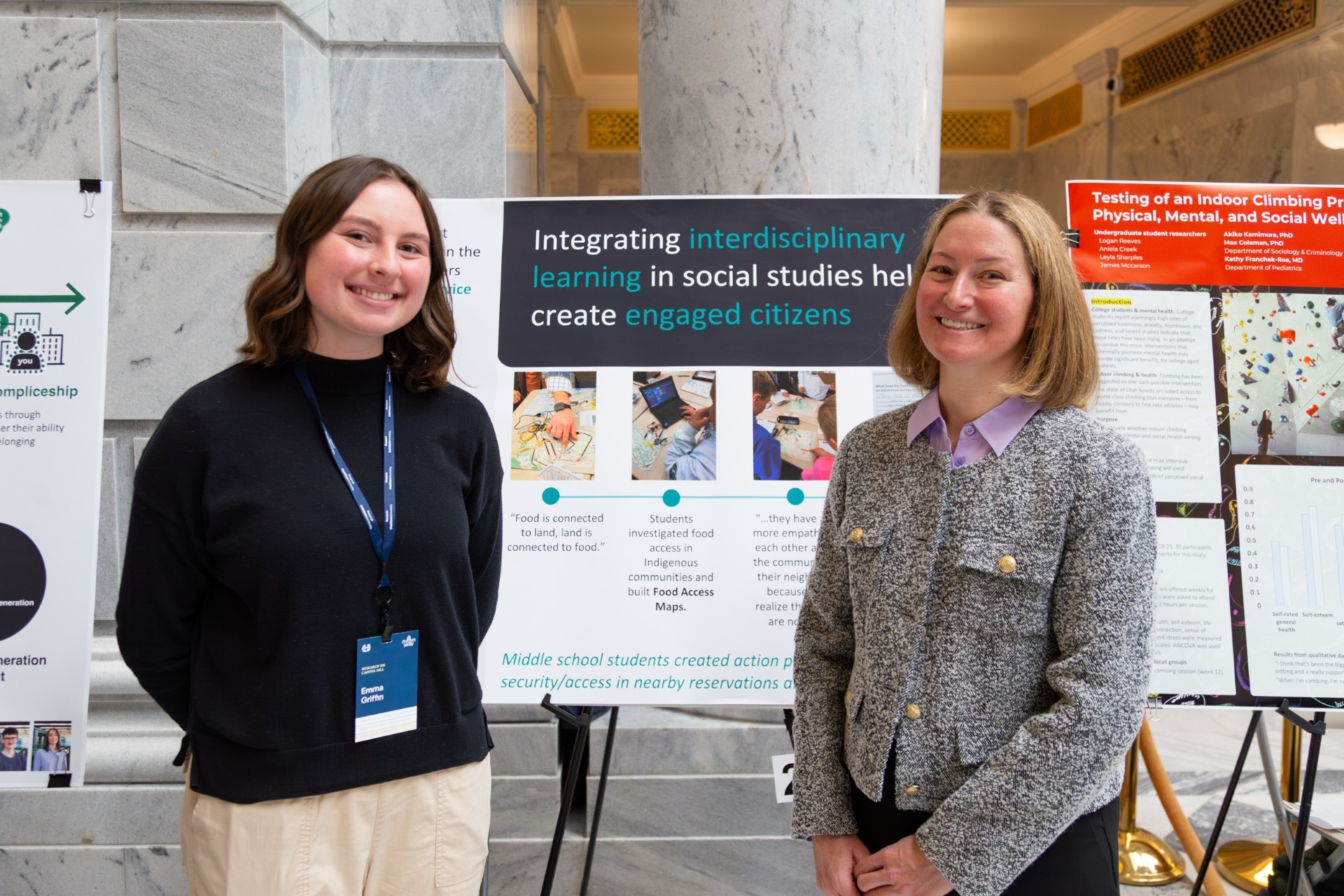 faculty member with an undergraduate researcher with their poster presentation