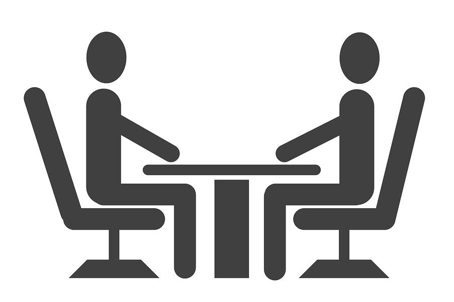 Cartoon of two people sitting across from each other at a desk